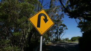 The picture is of a road sign signaling a u-turn to represent a financial turnaround.