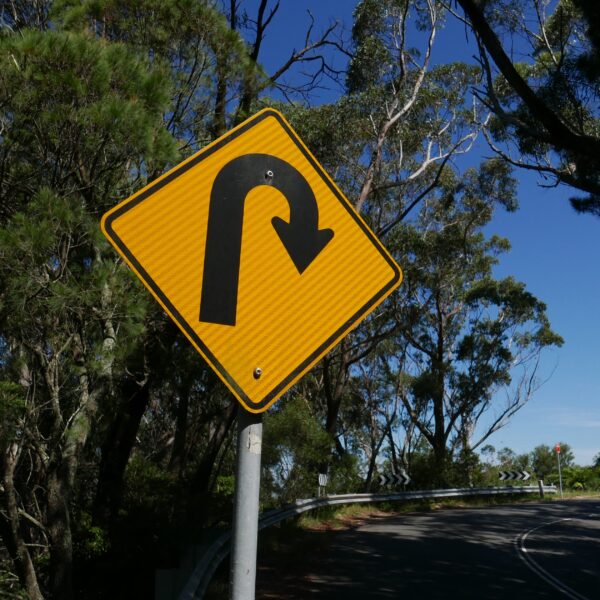The picture is of a road sign signaling a u-turn to represent a financial turnaround.