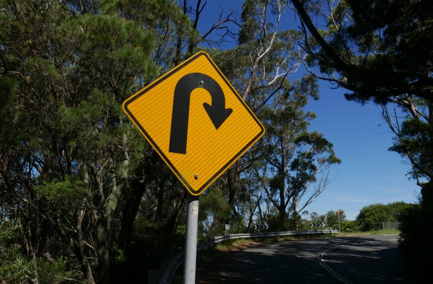 The picture is of a road sign signaling a u-turn to represent a financial turnaround.