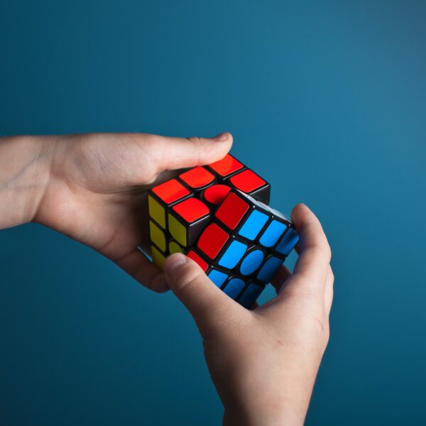 The picture shows someone solving a Rubik's cube to represent the desire to understand the problem and solve it.