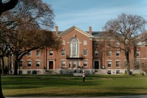 The picture shows a brick building on a university campus to represent college viability.