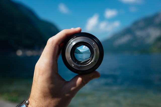 The picture shows a hand holding a lens, looking into the future figuratively. This represents five-year projections.