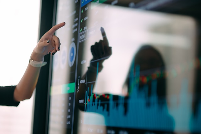 The picture shows a person presenting data as in the projections and stress testing in this article.